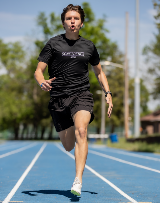 Person running on a track wearing a black t-shirt with 'CONFIDENCE' printed on it.