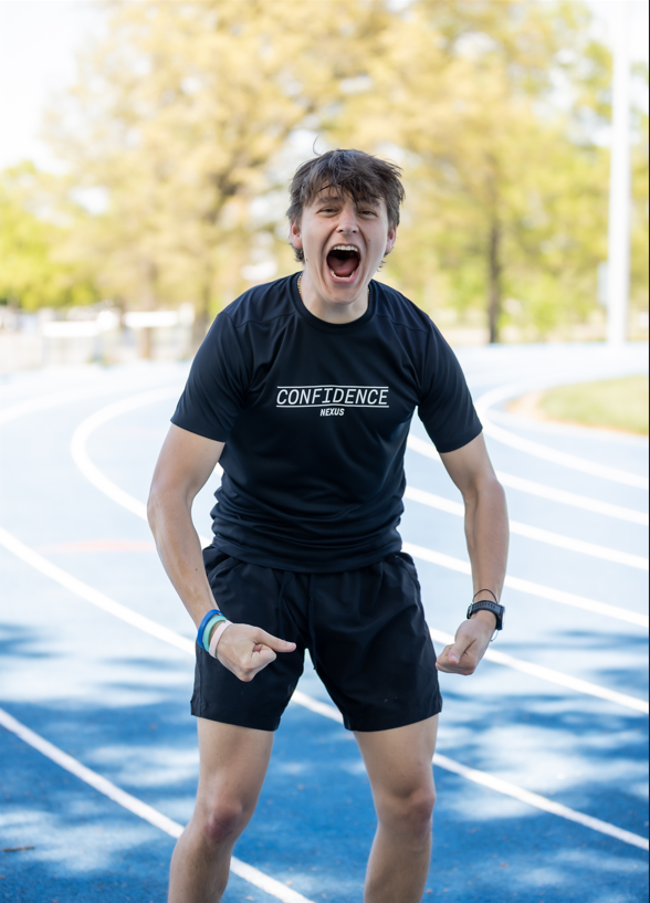 Person in athletic wear on a sports court with 'COMPETE' shirt